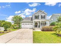 Charming two-story home with a two-car garage, landscaped yard, and welcoming front porch at 126 Dreamland Dr., Murrells Inlet, SC 29576