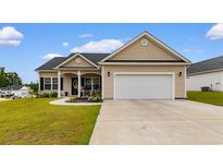 Charming single-story home featuring a two-car garage and a well-manicured front yard at 177 Baylee Circle, Galivants Ferry, SC 29544