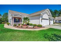 Charming single-story home with a well-manicured lawn, mature landscaping, and a two-car garage at 204 Rose Water Loop # 204, Myrtle Beach, SC 29588