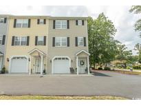 View of townhomes with front-entry garages and manicured landscaping for curb appeal at 2428 Little River Neck Rd. # 101, North Myrtle Beach, SC 29582