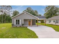 Charming single-story home with gray siding, covered parking, and a well-maintained front yard at 306 S Magnolia Ave., Andrews, SC 29510