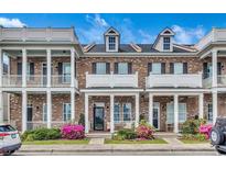 Charming brick townhome featuring a welcoming porch and manicured landscaping in a desirable community at 3477 Bristol Ln. # 3477, Myrtle Beach, SC 29577