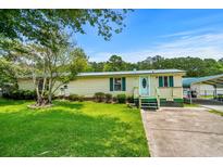 Charming single-story home featuring a well-manicured lawn, inviting porch, and a combination of siding and trim accents at 3839 Woodridge Circle, Little River, SC 29566
