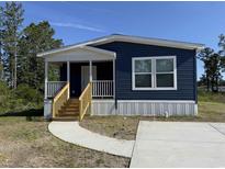 Charming, single-story home with navy blue siding and a welcoming front porch and wood stairs at 401 Cessna St, Myrtle Beach, SC 29577
