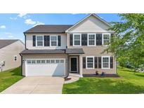 Charming two-story home with a white garage door, dark shutters, and a well-manicured lawn at 4115 Alvina Way, Myrtle Beach, SC 29579