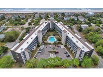 Enjoy the beautiful aerial view of this oceanfront condo with a swimming pool and on-site parking at 423 Parker Dr. # 334, Pawleys Island, SC 29585
