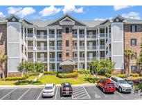 Multi-level condominium building with parking, landscaping, and a well-maintained facade at 4820 Magnolia Lake Dr. # 305, Myrtle Beach, SC 29577