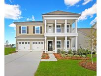 Charming two-story home with a welcoming porch, well-manicured lawn, and three-car garage at 5034 Selene Ct., Myrtle Beach, SC 29588