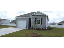 Charming one-story home with attached garage, well-manicured lawn, and a welcoming entrance at 575 Strawberry Field Way, Galivants Ferry, SC 29544