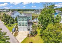 Charming two-story home with a two-car garage, screened porch and views of a tranquil pond at 601 46Th Ave. S, North Myrtle Beach, SC 29582