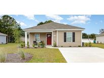 Charming single-story home with manicured lawn and a red front door, showcasing a welcoming facade at 651 Culmen Ct., Myrtle Beach, SC 29588