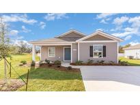 Charming single-story home with gray siding, complemented by a well-manicured lawn and lush landscaping at 659 Culmen Ct., Myrtle Beach, SC 29588
