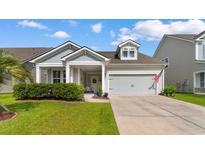 Charming single-story home with a well-manicured lawn and inviting covered porch at 765 Berkshire Ave., Myrtle Beach, SC 29577