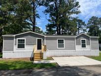 Charming single-story home with gray siding, white trim, and new wood porch at 800 Columbia Dr., Myrtle Beach, SC 29577