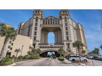View of the building exterior showing elegant architecture, grand entrance, and lush tropical landscaping at 100 North Beach Blvd. # 710, North Myrtle Beach, SC 29582