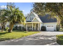 Charming one-story home with a well-manicured lawn and a beautiful palm tree at 1044 Martin Ln., Conway, SC 29526