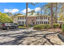 Elegant two-story home featuring a lush green yard and a private driveway with ample parking at 110-1 Whitetail Way # 1, Pawleys Island, SC 29585