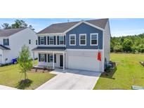 Charming two-story home featuring a well-manicured lawn and a two-car garage at 1102 Boswell Ct., Conway, SC 29526