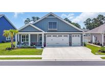 Charming single Gathering home featuring a two car garage, inviting front porch and manicured lawn at 1352 Jolly Roger Dr., North Myrtle Beach, SC 29582