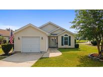 Charming single-story home featuring an attached garage and well-maintained front yard at 1407 Sunningdale Ln., Myrtle Beach, SC 29588