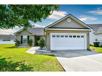 Charming home featuring a two-car garage and landscaped front yard at 1412 Reid Ct., Myrtle Beach, SC 29588