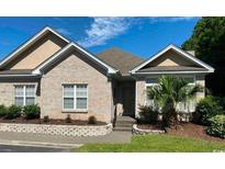 Charming brick home featuring well-maintained landscaping and mature trees at 1428 Saint Thomas Circle # B-1, Myrtle Beach, SC 29577