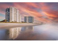Oceanfront condo towers with a beautiful view of the beach and colorful sunset sky at 161 Seawatch Dr. # 710, Myrtle Beach, SC 29572