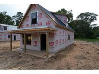 New construction home featuring durable materials and a simple porch design at 402 S Magnolia Ave., Andrews, SC 29510
