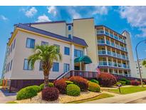 Inviting condo building featuring manicured landscaping and classic architectural elements at 4525 S Ocean Blvd. # 406, North Myrtle Beach, SC 29582