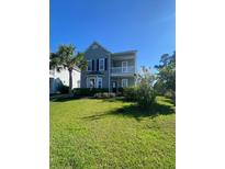 Charming two-story home with a well-maintained lawn and beautiful landscaping at 493 Emerson Dr., Myrtle Beach, SC 29579