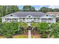 Attractive multi-Gathering home with a pathway, covered entryways and balconies, and lush landscaping at 5825 Catalina Dr. # 523, North Myrtle Beach, SC 29582