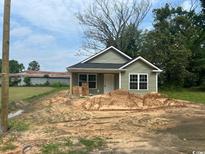 Charming single-story home with light green siding, a black roof, and a landscaped yard at 608 Miles Ct, Marion, SC 29571