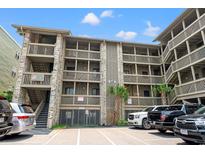Coastal condo building exterior showcases well-maintained balconies and convenient parking at 618 N Waccamaw Dr. # A-5, Murrells Inlet, SC 29576