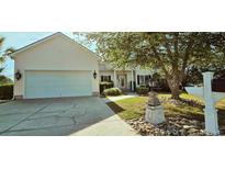 Charming home with a two-car garage, landscaped front yard, and mature trees offering ample shade at 618 Wintercreeper Dr., Longs, SC 29568