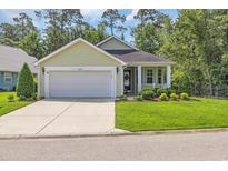 Charming single-story home with a well-manicured lawn and inviting curb appeal at 628 Grand Cypress Way, Murrells Inlet, SC 29576