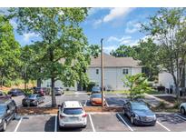 Exterior shot of a two-story condo building with ample parking at 6309 Sweetwater Blvd., Murrells Inlet, SC 29576