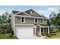Charming two-story home with vertical siding, a two-car garage, and professionally landscaped front yard at 6332 Swainson Street Sw, Ocean Isle Beach, NC 28469