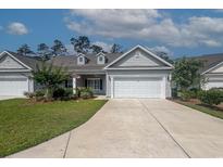 Charming single-story home with well-maintained landscaping and an attached two-car garage at 648 Sunnyside Dr. # 102, Murrells Inlet, SC 29576