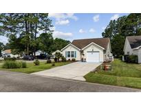 Charming single-story home featuring a manicured lawn, attached garage, and inviting curb appeal at 6681 Wisteria Dr., Myrtle Beach, SC 29588