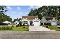 Charming single-story home with a well-manicured lawn, attached garage, and inviting curb appeal at 6681 Wisteria Dr., Myrtle Beach, SC 29588