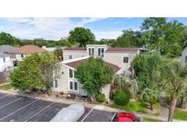 Inviting exterior view of home with mature trees, an American flag and private parking at 800 9Th Ave. S # E-4, North Myrtle Beach, SC 29582