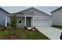 Charming single-Gathering home with a light gray exterior, attached garage, and well-manicured lawn at 1042 Laconic Dr., Myrtle Beach, SC 29588