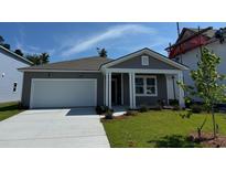Charming single-story home featuring a gray exterior, covered entry, and attached garage at 1043 Laconic Dr., Myrtle Beach, SC 29588
