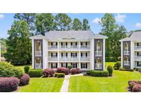 Three story condo building with multiple balconies, brick accents, manicured lawn and shrubs at 1208 River Oaks Dr. # 24-B, Myrtle Beach, SC 29579
