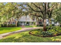 Stunning brick home with mature trees and a circular driveway provides great curb appeal at 1259 Oatland Lake Rd., Pawleys Island, SC 29585