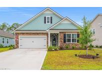 Charming single-Gathering home with stone and shake siding, manicured lawn and attached two-car garage at 1523 Wood Stork Dr., Conway, SC 29526