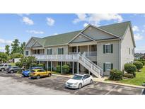 Well-maintained condo with green roof, white railing, and convenient parking at 141 Lazy Willow Ln. # 103, Myrtle Beach, SC 29577