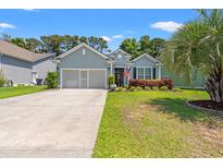 Charming single-story home with a well-manicured lawn and an attached garage at 229 Coral Beach Circle, Surfside Beach, SC 29575
