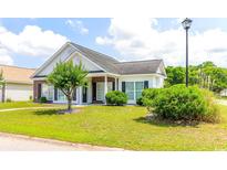 Charming one-story home with lush green lawn and manicured landscaping at 2499 Burning Tree Ln., Little River, SC 29566