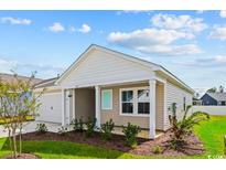 Charming single-story home with light beige siding, a manicured lawn, and inviting front porch at 3027 Deerberry Place, Longs, SC 29568